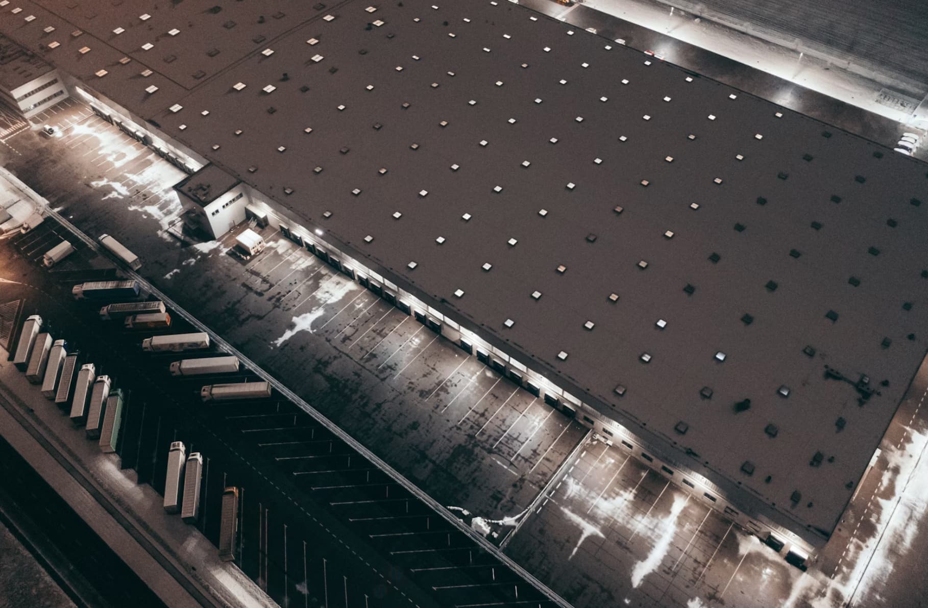 Aerial view of a distribution warehouse and yard operations, reflecting shipment visibility across the supply chain